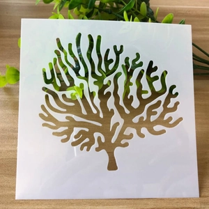 DIY drawing template with coral pattern on white PET stencil over wooden surface
