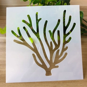 White DIY coral stencil template made of flexible PET plastic on a wooden background