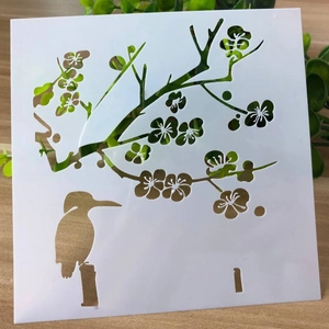 Macro shot of flexible plastic DIY painting stencil with floral and bird cutout patterns