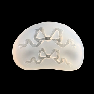 Translucent silicone mold with two bow shapes for DIY crafts and fondant decor