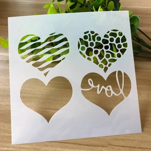 Detail of square plastic stencil with four heart patterns including zebra and love text