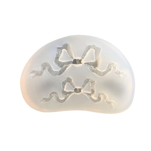 Translucent silicone mold featuring elegant bow shapes with ribbon detail for DIY crafts