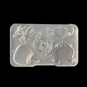 Detailed view of 5-cavity silicone mold with heart, pumpkin carriage and star shapes