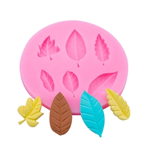 Macro detail of pink leaf silicone mold showing intricate texture on fondant leaves