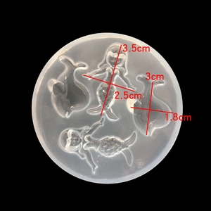 Macro detail of silicone mold cavities featuring mermaid and dolphin shapes with dimensions