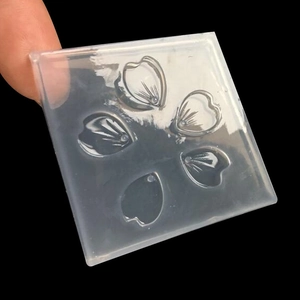 Detailed macro view of square silicone mold with five cherry blossom petal cavities