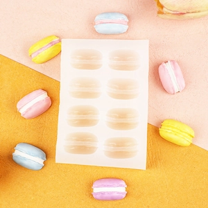 Top view of eight semi-transparent silicone macaron molds for DIY candle making and baking
