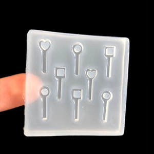 Close-up of silicone resin mold with 8 cavities for heart and geometric earrings
