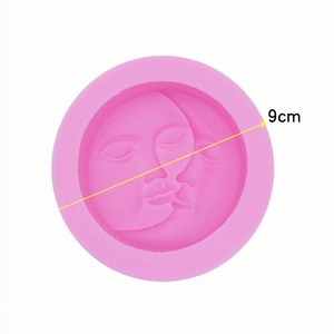 Pink circular silicone mold with 9cm diameter sun and moon face relief design