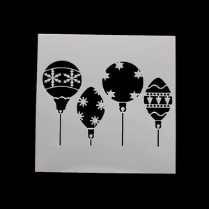 Detail of flexible plastic Christmas stencils featuring four festive hanging ball patterns