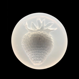 Macro detail of round silicone mold featuring textured strawberry cavity for DIY resin crafts