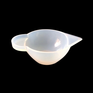 Translucent silicone measuring cup for resin DIY with handle and spout on black background