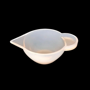 Detail of translucent silicone measuring cup with a precision pouring spout and handle