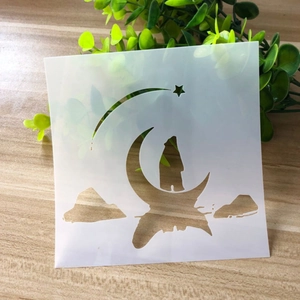 Detailed view of hollow drawing stencil with wolf and moon pattern on wooden surface