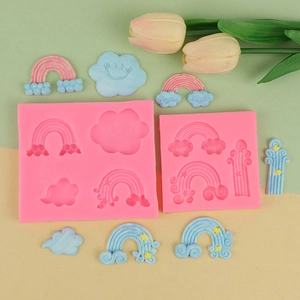 Detail view of pink rainbow and cloud silicone molds with finished fondant decorations