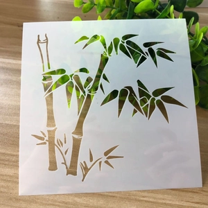 DIY bamboo painting stencil made of flexible white plastic on a wooden table background