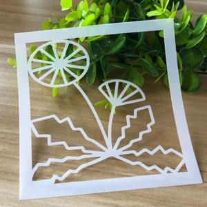 Detail of white dandelion stencil for painting on natural wood texture background