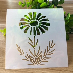 Macro view of white translucent daisy flower stencil on a light wooden background