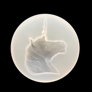 Unicorn head silicone mold for DIY resin jewelry making and phone case decor on black surface