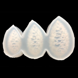 Translucent silicone mold with three pinecone shapes for DIY resin crafts on black background