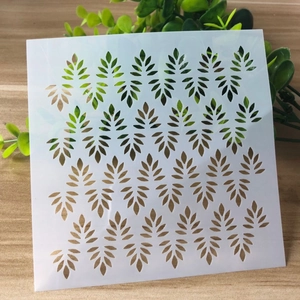 Macro detail of square leaf stencil for DIY painting on a wooden texture background