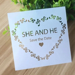 Macro detail of white square PET hollow stencil with Save the Date wedding heart pattern