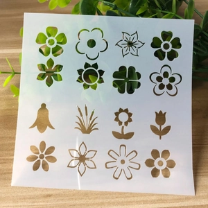 Close-up of heart and flower DIY painting stencils on a warm wooden surface