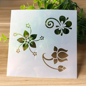White semi-transparent PET plastic stencil with floral and star cutout patterns