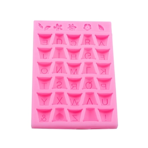 Pink silicone alphabet mold with A-Z letters and flower decorative elements for baking