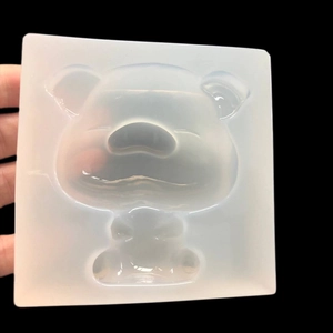 Handheld view of a transparent silicone pig mold for UV resin and DIY jewelry making