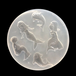 Macro shot of 5-cavity silicone mold featuring mermaid and dolphin shapes for DIY resin art