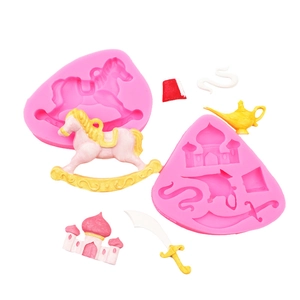 Macro detail of silicone molds showing castle, rocking horse, and magic lamp fondant shapes