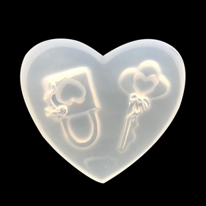 Translucent heart silicone mold featuring detailed key and padlock designs for DIY crafts