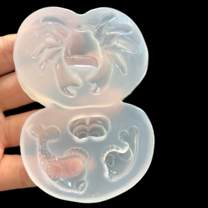 Detailed translucent silicone mold showing intricate crab and small fish patterns for DIY crafts