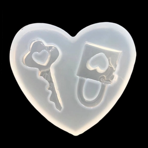 Macro view of heart-shaped silicone mold featuring key and lock cavity designs for DIY crafts
