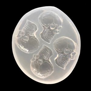 Translucent silicone mold with four skull cavities for DIY resin crafts and jewelry