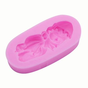Detailed view of pink silicone mold with intricate angel relief for handmade soap crafting