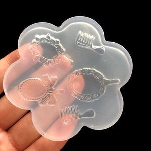 Detailed macro view of vintage mirror and comb patterns inside a silicone mold