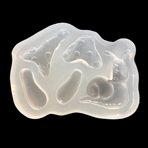 Macro view of transparent silicone mold with mushroom and snail shapes for DIY crafts