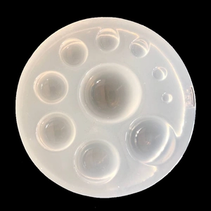 Macro top view of nine-hole semi-transparent silicone mold for round resin jewelry