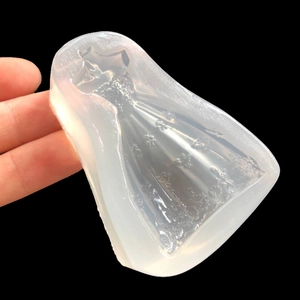 Handheld view of a semi-transparent silicone wedding dress mold for DIY resin crafts