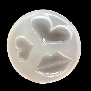 Detail showing round silicone mold with heart and lip shapes for DIY resin crafts