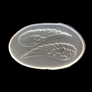 Translucent silicone mold featuring symmetrical angel wing patterns for DIY resin crafts