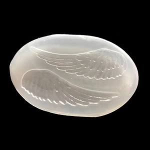 Macro view of transparent silicone mold with detailed angel wing patterns for DIY resin crafts