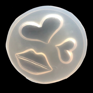 Silicone mold with heart and lip shapes for DIY resin crafts on a black background