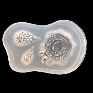 Translucent silicone mold featuring two hedgehogs and a mushroom tree stump for DIY resin