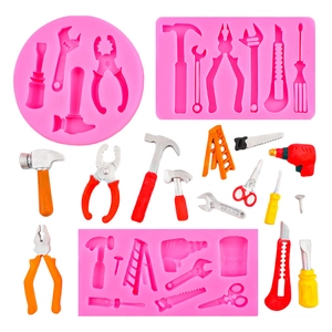 Pink silicone cake mold set featuring detailed hammer, pliers, and hardware tool shapes