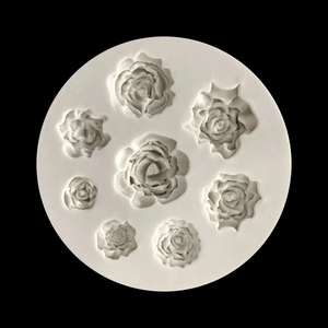 Macro shot of 7 rose flower cavities on white silicone mold for fondant cake decorating