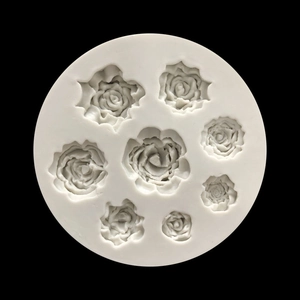 Top view of white silicone mold with 8 detailed rose flower shapes for fondant and resin