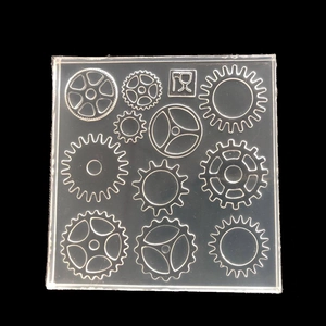Macro shot of square silicone mold with various gear designs and food-grade safety logo